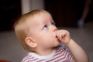infant-boy-sucking-thumb-at-pediatric-dentist-in-alpharetta-ga