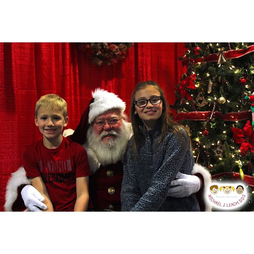 older_brother_and_sister_smiling_with_Santa
