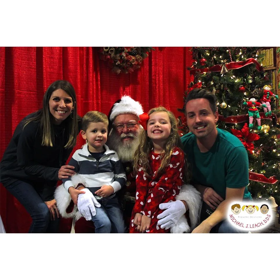 Young_Family_Smiling_with_Santa_visit_Pediatric_dentist