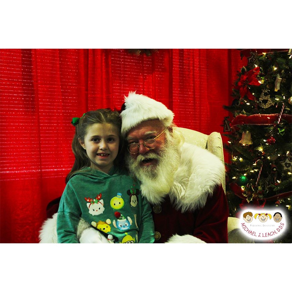 brunette_girl_smiling_with_Santa