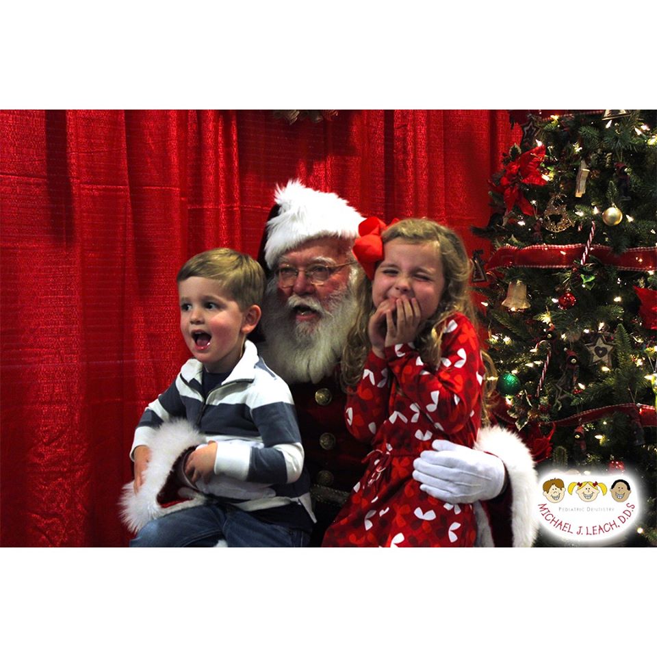 giggling_brother_and_sister_seeing_Santa