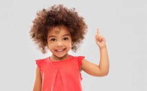 Smiling child pointing upwards